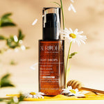 Flacon Light Drops posé avec camomille et cuillère de miel – Chogan – Aurodhea