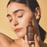 Femme appliquant ULTRA OIL™ antioxydant sur la peau – soin éclat et hydratation
